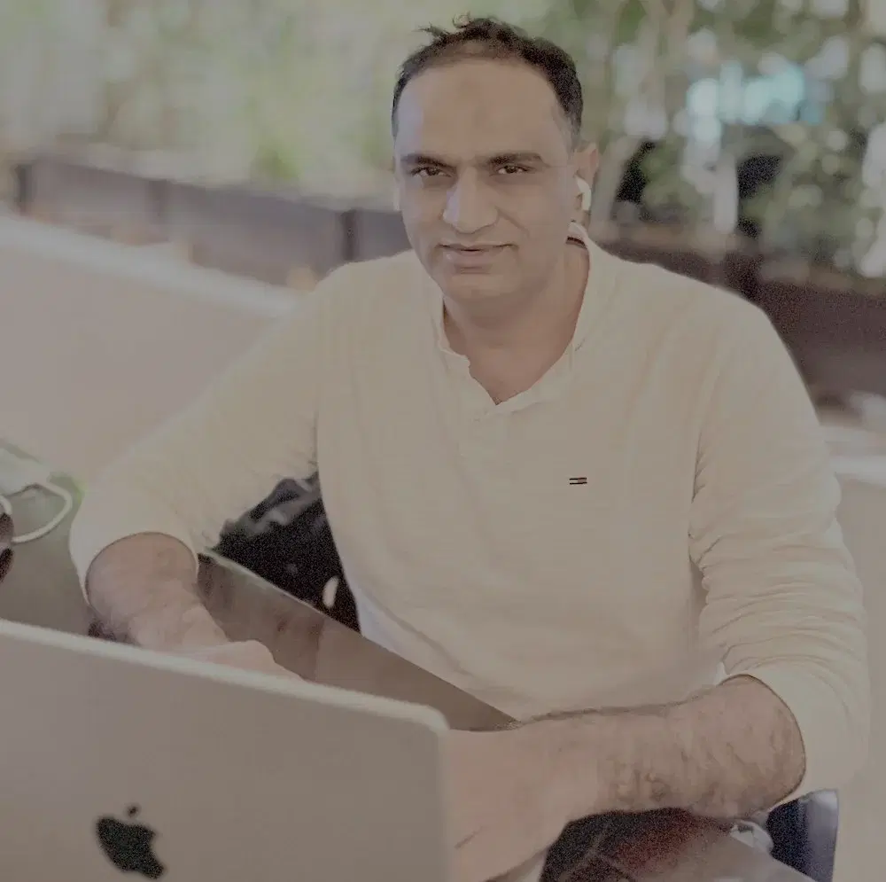 Burhan Surti, Founder and CEO of Logibee, in a professional portrait at a modern workspace.